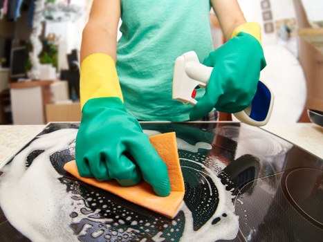Professional cleaner inspecting carpet cleaning machine and hoses for safety